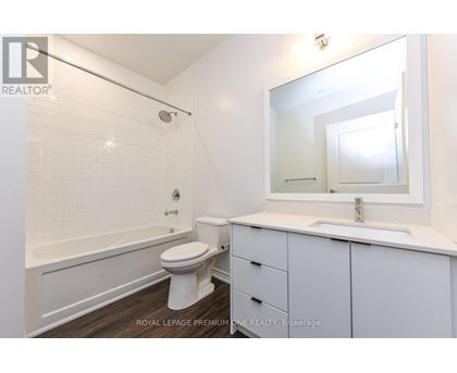 A white bathroom with a toilet, sink, and bathtub.