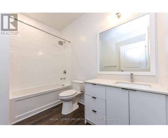 A white bathroom with a toilet, sink, and bathtub.