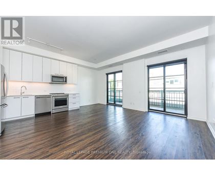 A spacious kitchen with white cabinets and a microwave above the stove.