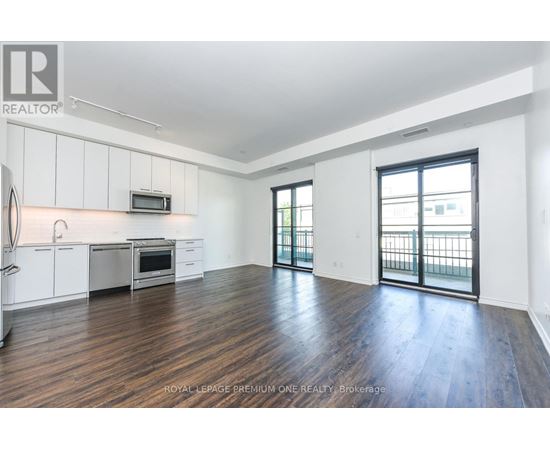 A spacious kitchen with white cabinets and a microwave above the stove.