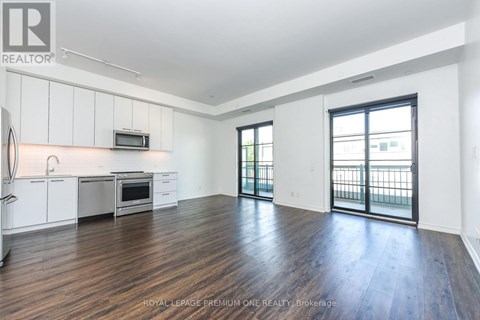 A spacious kitchen with white cabinets and a microwave above the stove.