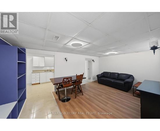 A living room with a dining table and chairs.