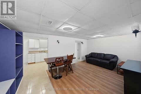 A living room with a dining table and chairs.