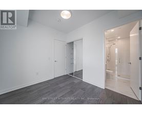 A spacious room with a doorway leading to another room.