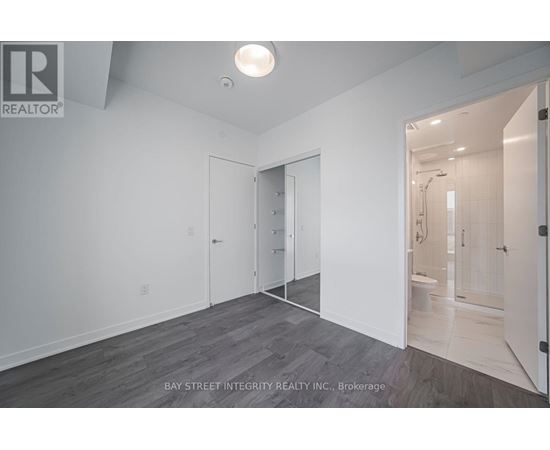 A spacious room with a doorway leading to another room.