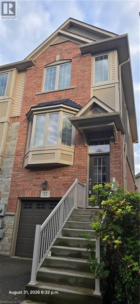 A house with a red brick exterior and a garage door numbered 32.