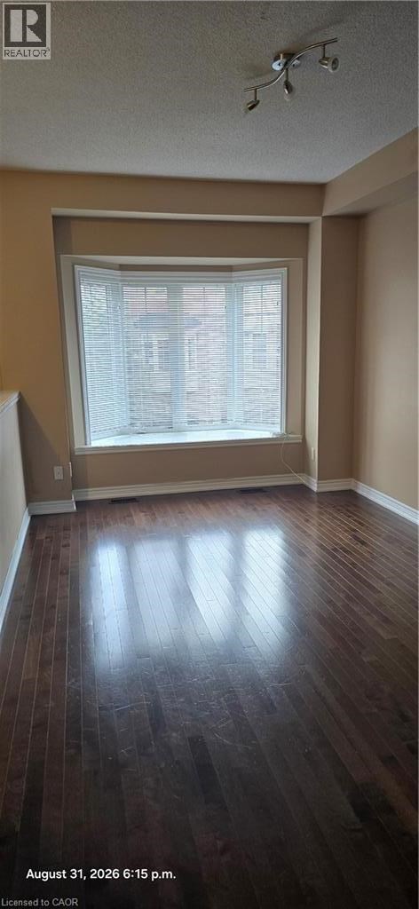 A room with a window and wooden flooring.