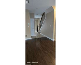 A person is walking up a staircase in a house.