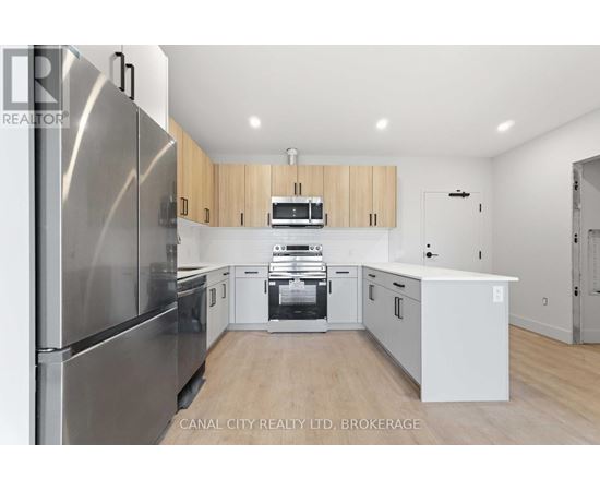 A modern kitchen with wooden cabinets and stainless steel appliances.