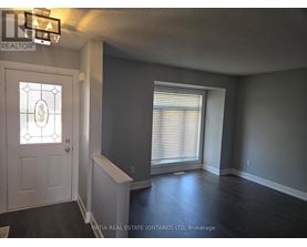 A room with a door and a window with blinds.