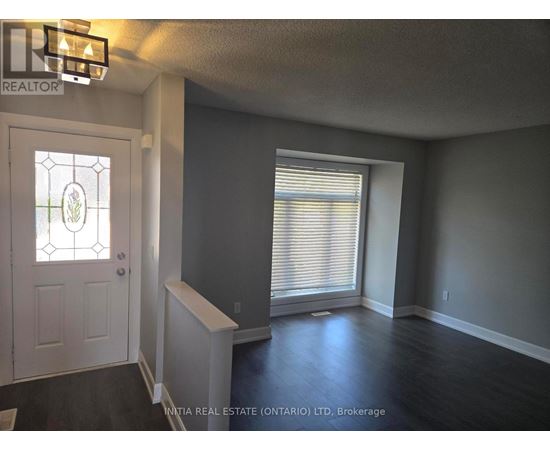 A room with a door and a window with blinds.