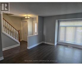 A room with a staircase and a window.