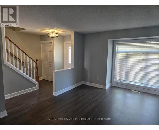 A room with a staircase and a window.