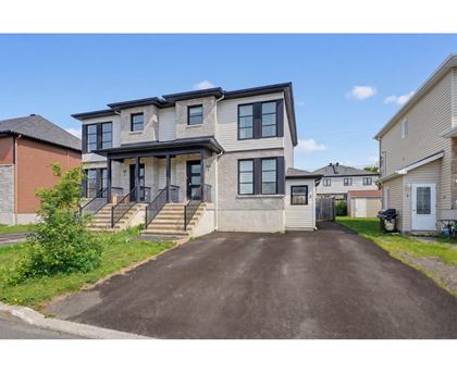 A two-story house with a driveway in front.