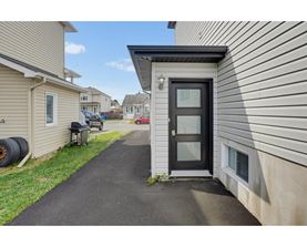 A black door is on the side of a house.
