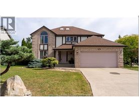 A large house with a brown roof and a garage door.