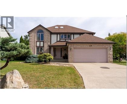 A large house with a brown roof and a garage door.