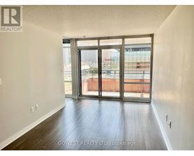 A room with a sliding glass door leading to a balcony.
