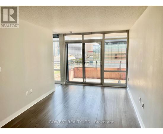 A room with a sliding glass door leading to a balcony.