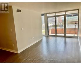 A room with a sliding glass door leading to a balcony.