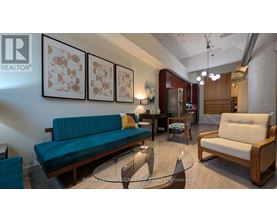 A living room with a couch, chairs, and a coffee table.