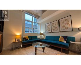 A living room with a blue couch and a coffee table.