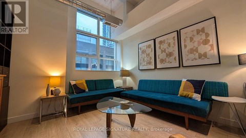 A living room with a blue couch and a coffee table.