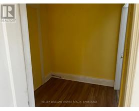 A room with yellow walls and wooden floors.