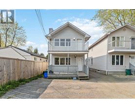 A two-story house with a garage is for sale.
