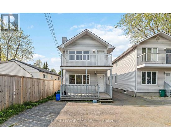 A two-story house with a garage is for sale.