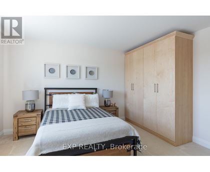A bedroom with a bed, nightstands, and a wardrobe.