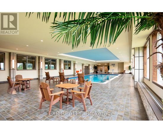 A large room with a pool table and chairs.