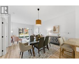 A dining room with a table set for six and a view of the backyard.