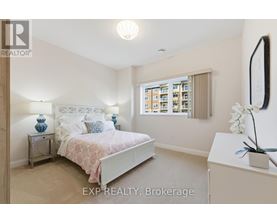 A bedroom with a bed, nightstand, and a window with a view of a building.