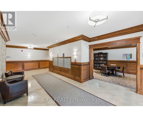 A well-lit office lobby with a reception desk and a bookshelf.