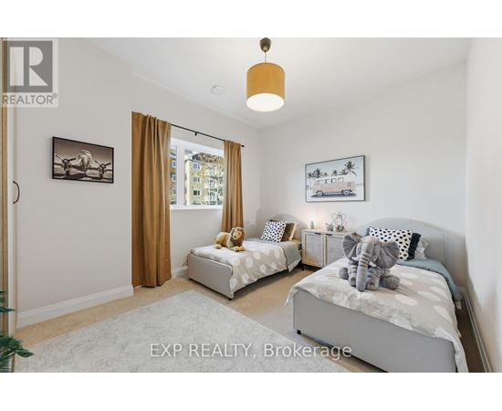 A bedroom with two beds and a window with curtains.
