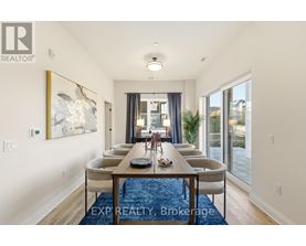 A dining room with a long table and chairs.