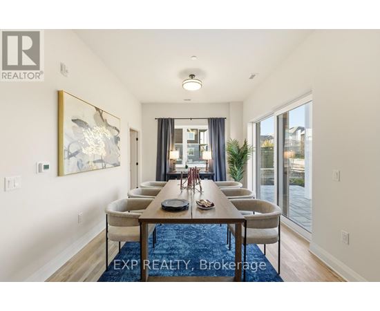 A dining room with a long table and chairs.