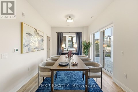 A dining room with a long table and chairs.