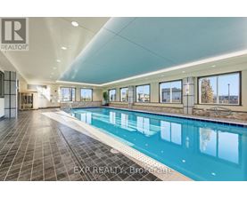 A large indoor swimming pool with tiled floors and walls.