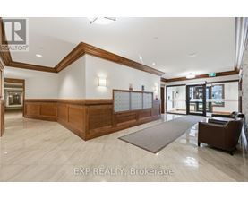 A reception area with a wooden reception desk and a brown armchair.