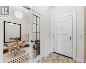 A white door is open to a room with a table and chairs.
