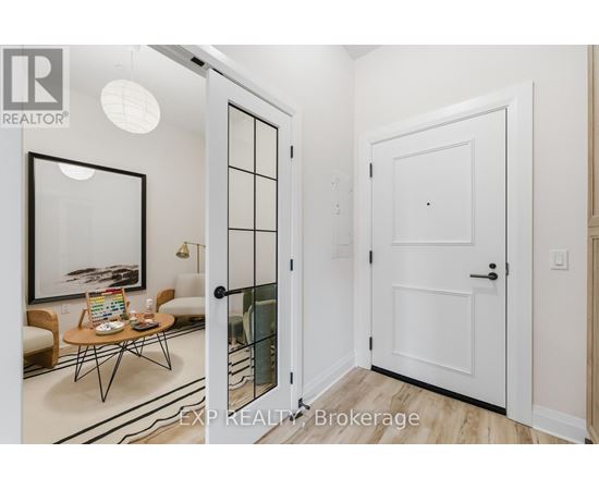 A white door is open to a room with a table and chairs.