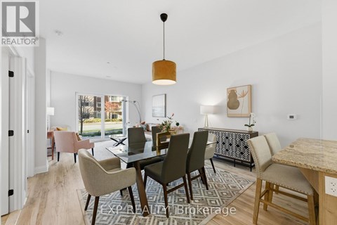 A dining room with a table set for six and a view of the backyard.