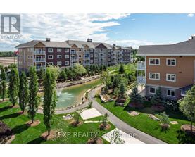 A real estate photo of a building with a pool in the foreground.