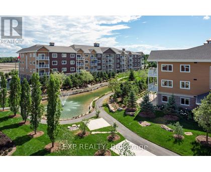 A real estate photo of a building with a pool in the foreground.