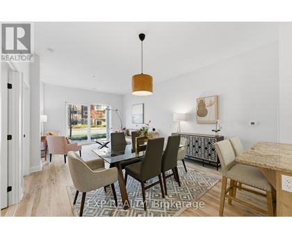 A dining room with a table set for six and a view of the backyard.
