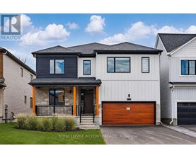 A modern house with a garage door is for sale.