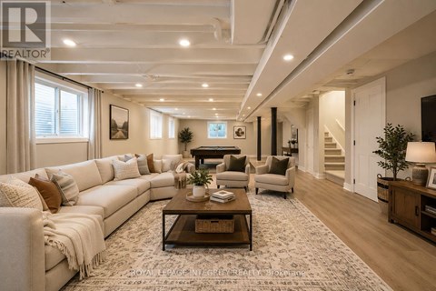 A spacious living room with a white sofa set and a coffee table.