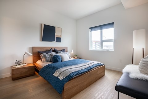 A bedroom with a large bed and a window.